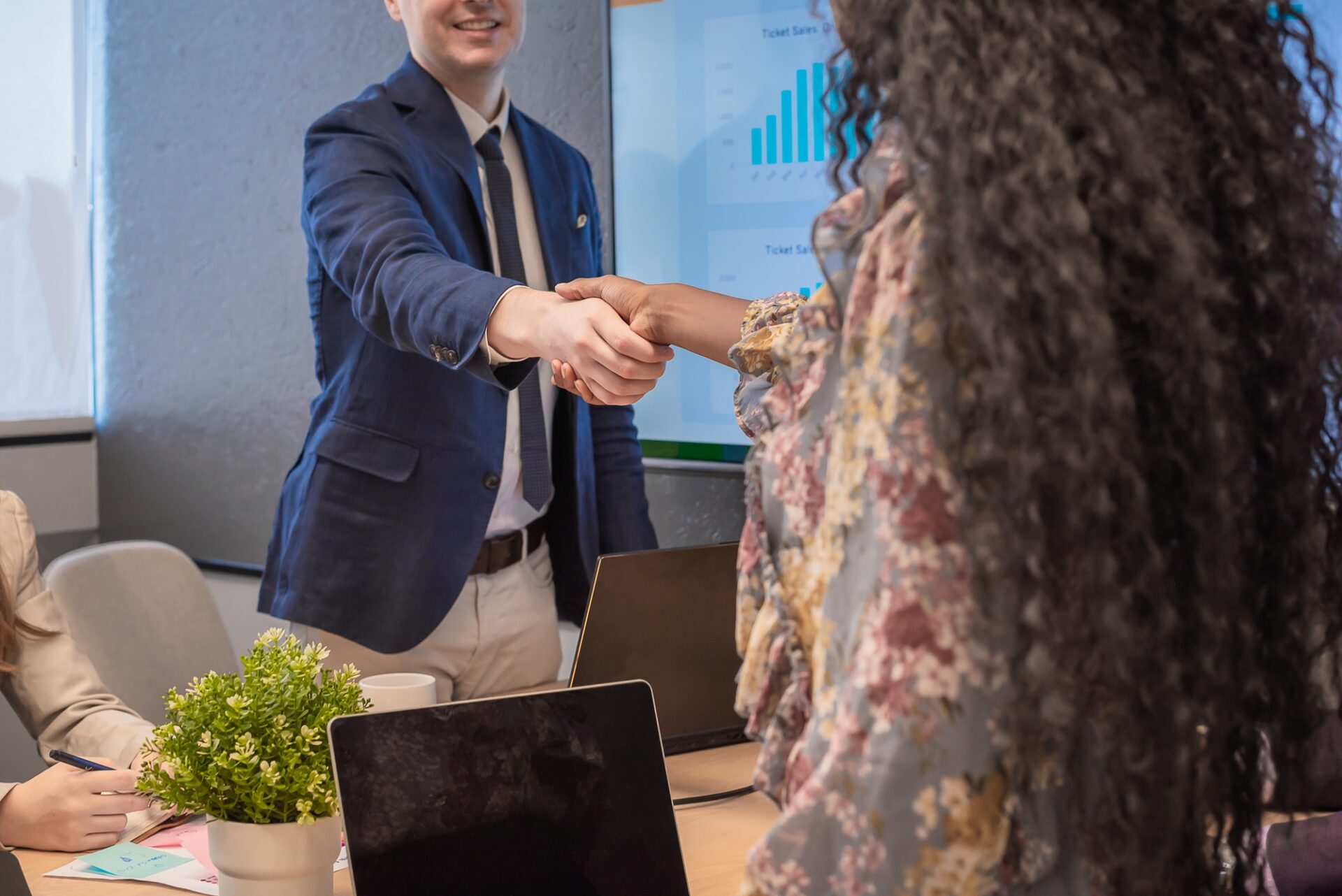 Business man shake hands with business women agreeing on partnerships or introducing themselves