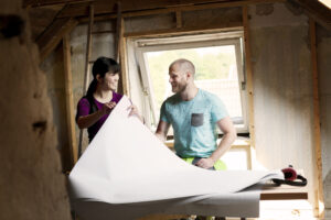 Two people reviewing plans during a home renovation