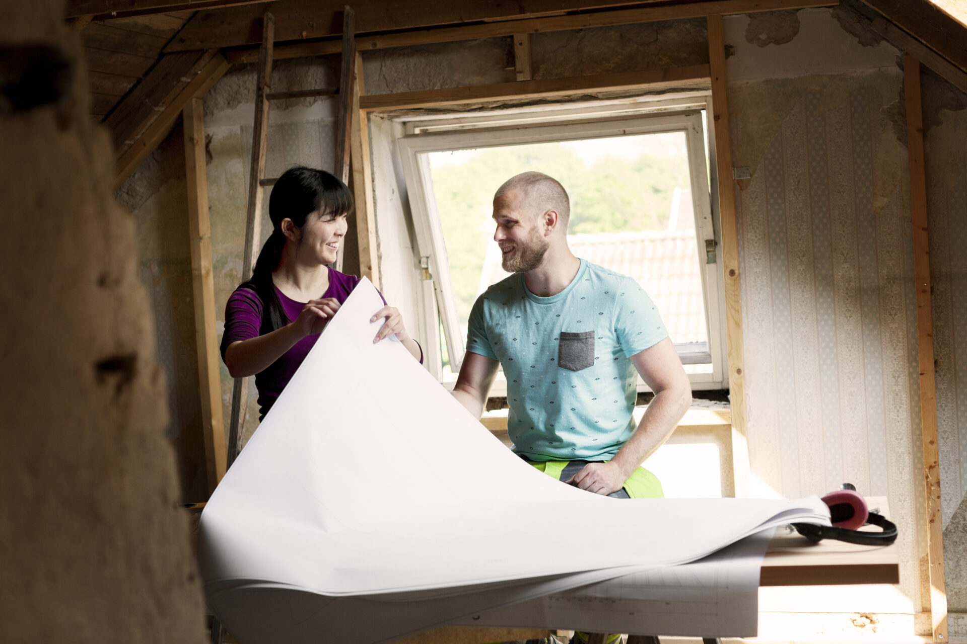 Two people reviewing plans during a home renovation